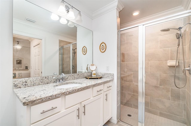 bathroom featuring vanity, crown molding, and a shower with shower door