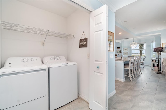 laundry area with a notable chandelier, independent washer and dryer, and crown molding