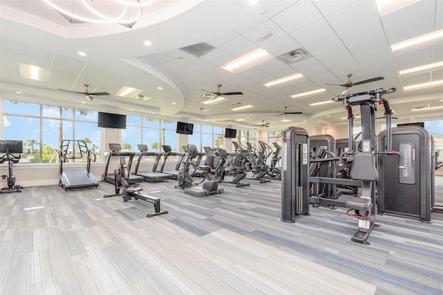 gym featuring a paneled ceiling and light colored carpet