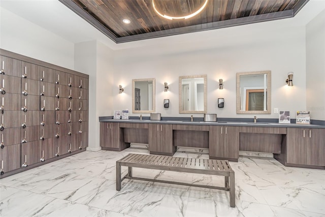 bathroom featuring vanity, wood ceiling, a tray ceiling, and a high ceiling