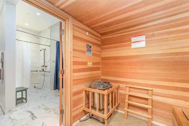 view of sauna / steam room featuring wooden ceiling and wood walls