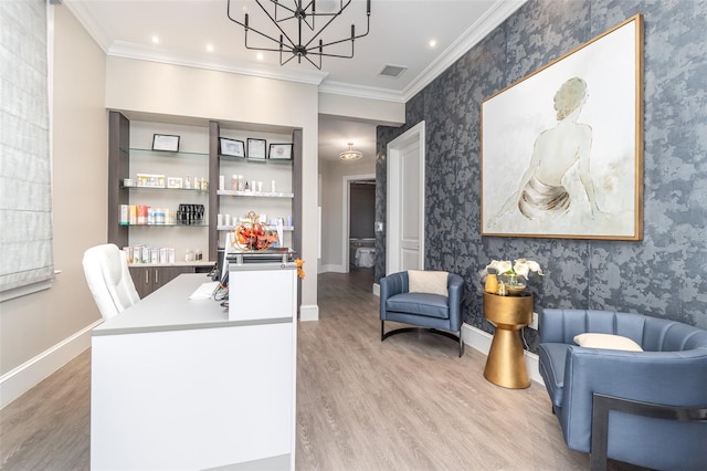 office space with crown molding, an inviting chandelier, and light wood-type flooring