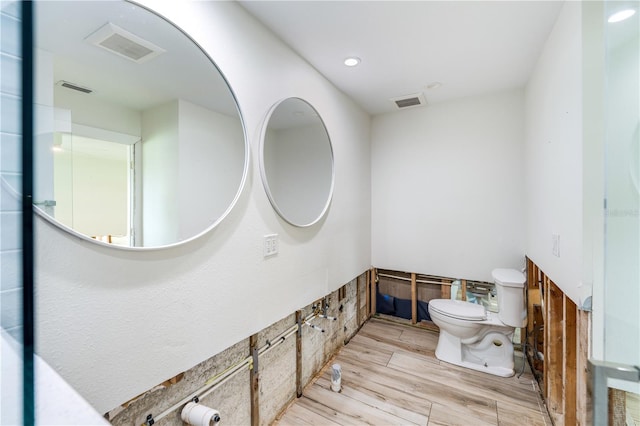 bathroom featuring hardwood / wood-style flooring and toilet