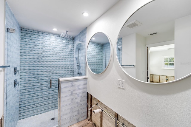 bathroom with a shower with door, tile walls, and hardwood / wood-style floors