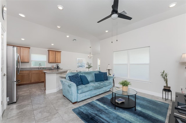 living room with sink, light tile patterned floors, and ceiling fan