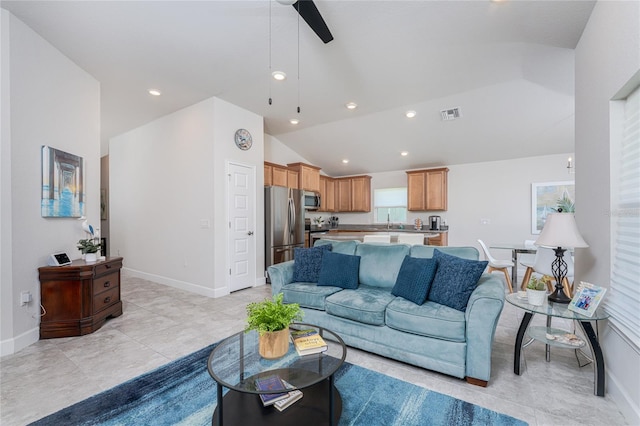 tiled living room featuring sink, high vaulted ceiling, and ceiling fan