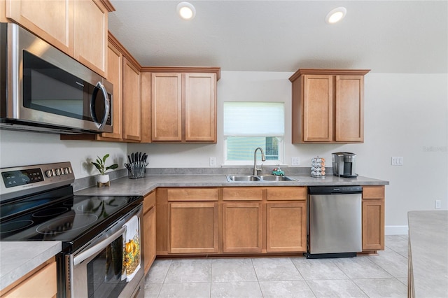 kitchen featuring stainless steel appliances, sink, and light tile patterned floors