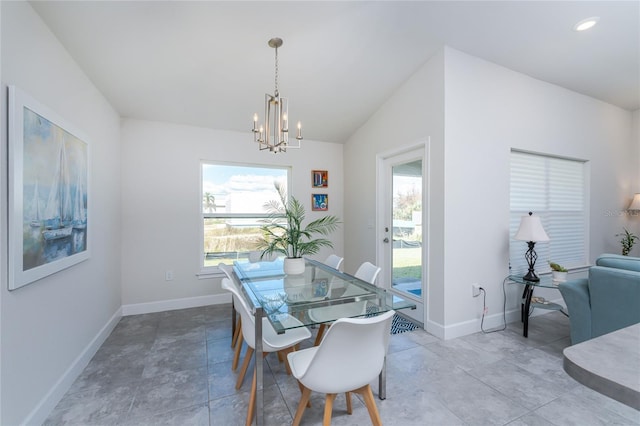 dining room with lofted ceiling and an inviting chandelier