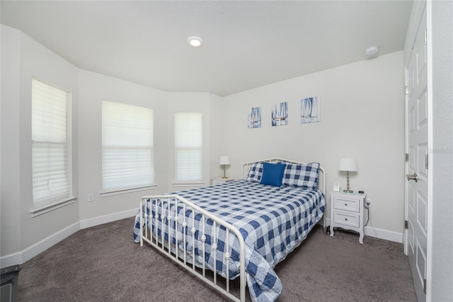 bedroom featuring dark colored carpet