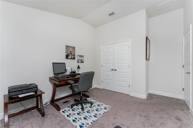 home office with vaulted ceiling and light colored carpet