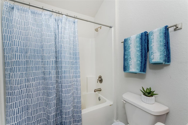 bathroom featuring toilet and shower / bath combo