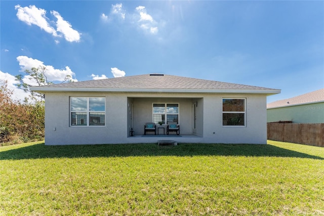 back of house featuring a patio and a yard