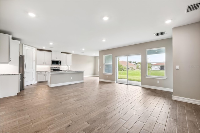 25236 Rampart Blvd, Punta Gorda, FL 33983 - unfurnished living room featuring light wood finished floors and recessed lighting