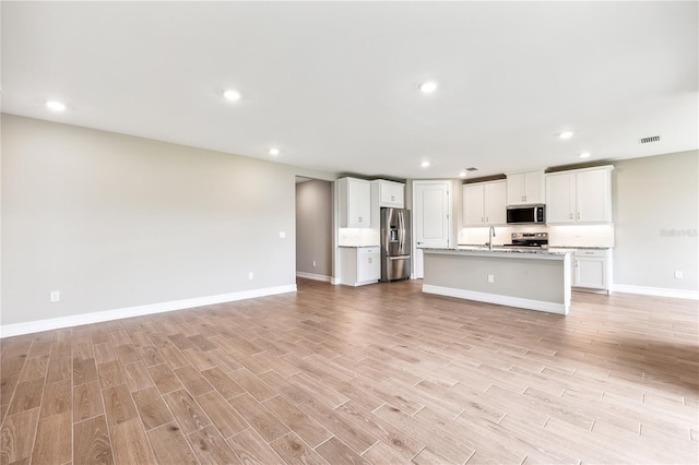 25236 Rampart Blvd, Punta Gorda, FL 33983 - unfurnished living room with light wood-type flooring and recessed lighting