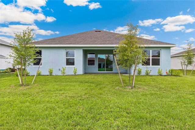 25236 Rampart Blvd, Punta Gorda, FL 33983 - back of house with stucco siding, a yard, and a shingled roof