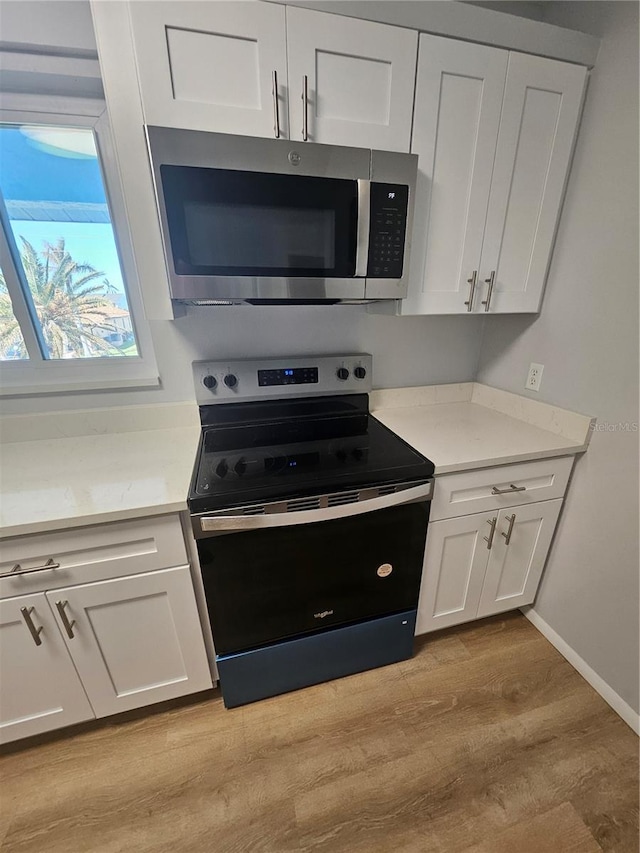 kitchen featuring light hardwood / wood-style floors, white cabinetry, and stainless steel appliances