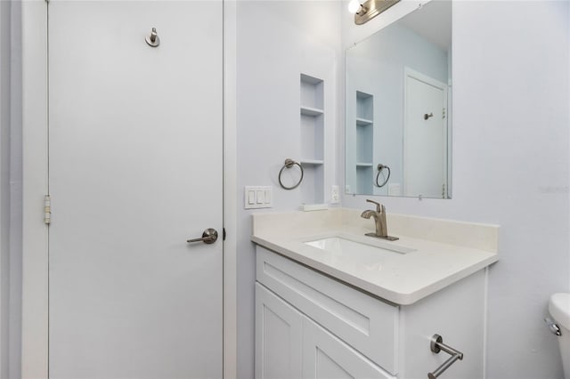 bathroom featuring vanity and toilet