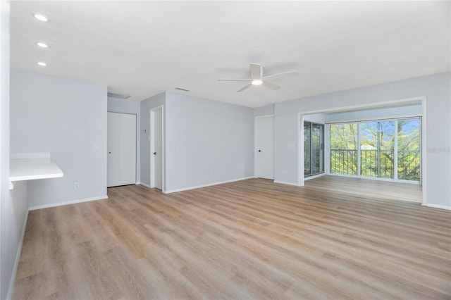 unfurnished living room featuring light wood-type flooring and ceiling fan