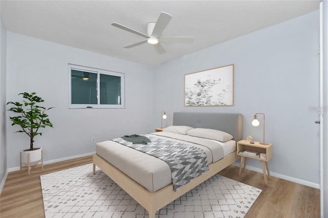 bedroom with wood-type flooring and ceiling fan