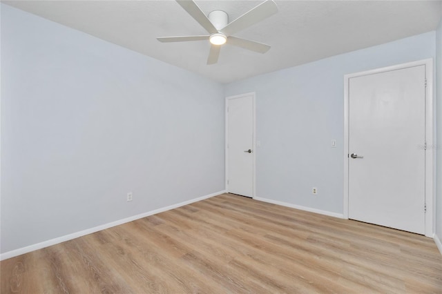 spare room with light hardwood / wood-style floors and ceiling fan