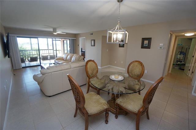 tiled dining room featuring ceiling fan with notable chandelier