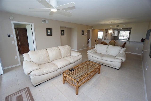 tiled living room with ceiling fan