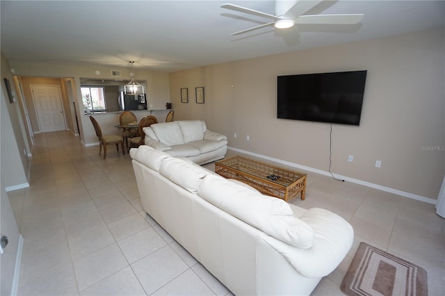 living room featuring light tile patterned floors and ceiling fan