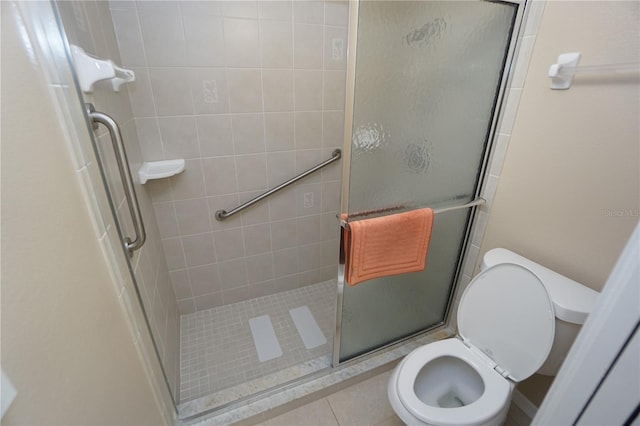 bathroom with toilet, an enclosed shower, and tile patterned flooring