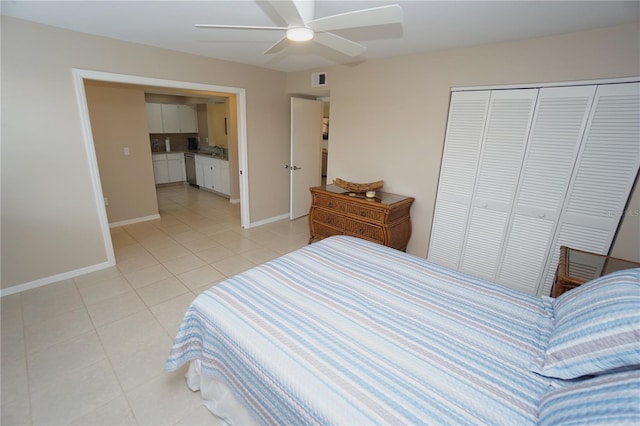 tiled bedroom featuring sink, a closet, and ceiling fan