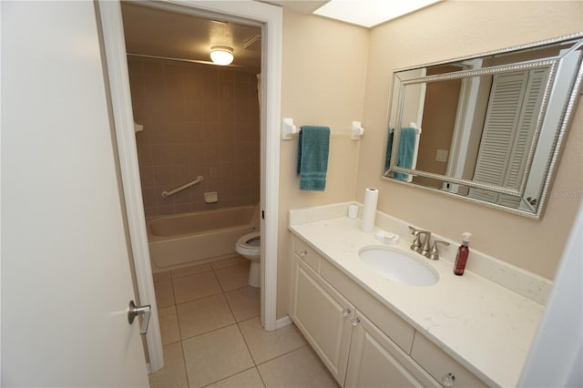 full bathroom featuring tiled shower / bath, vanity, toilet, and tile patterned floors