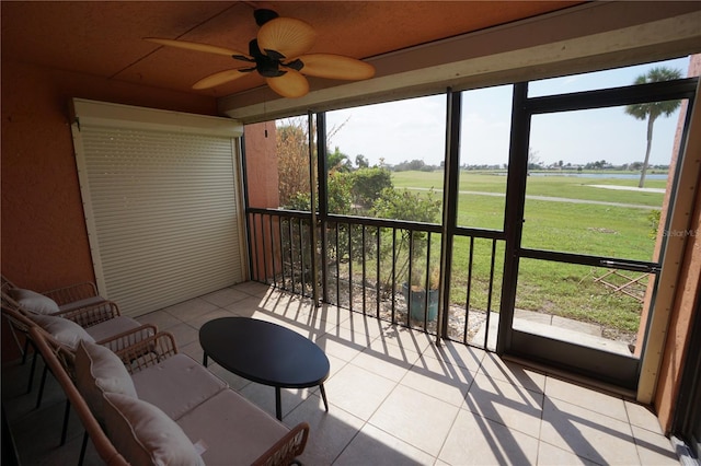 sunroom / solarium with a rural view, ceiling fan, and plenty of natural light