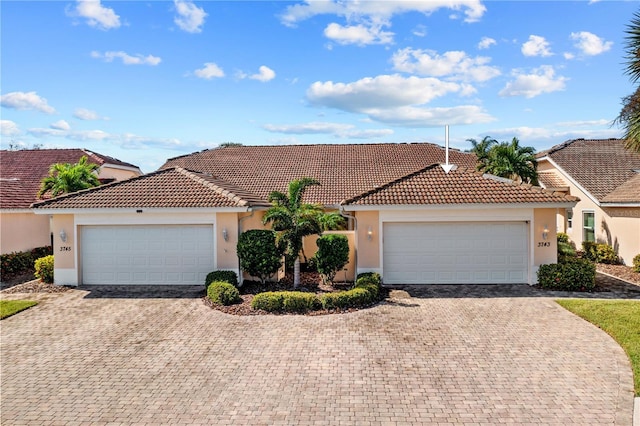 3743 Albacete Cir Unit 84, Punta Gorda, FL 33950 - mediterranean / spanish-style home featuring stucco siding, a garage, driveway, and a tile roof