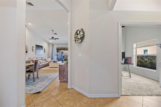 3743 Albacete Cir Unit 84, Punta Gorda, FL 33950 - corridor featuring arched walkways, light tile patterned floors, baseboards, and light carpet