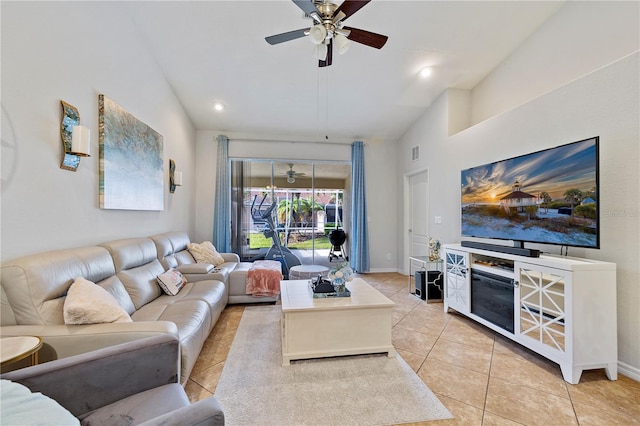 living room with light tile patterned floors, vaulted ceiling, and ceiling fan