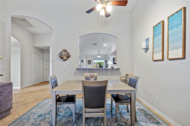 tiled dining room featuring ceiling fan