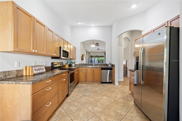 kitchen with sink, ceiling fan, stainless steel appliances, and light tile patterned floors