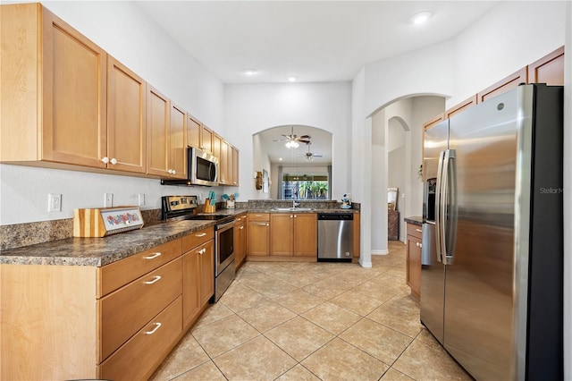 3743 Albacete Cir Unit 84, Punta Gorda, FL 33950 - kitchen with appliances with stainless steel finishes, arched walkways, a sink, and dark countertops