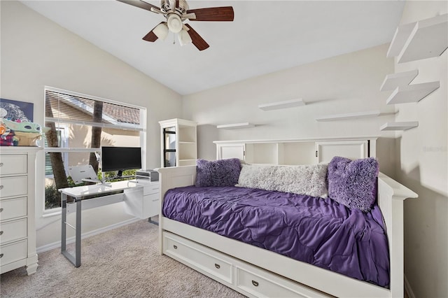 carpeted bedroom with ceiling fan and vaulted ceiling