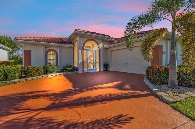 mediterranean / spanish house with a garage