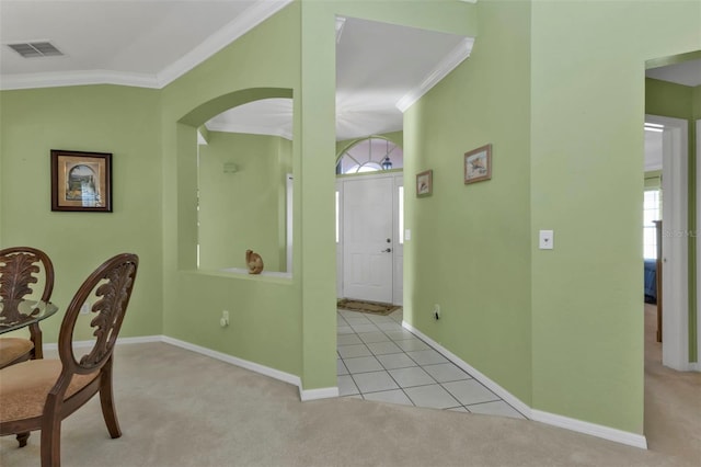 carpeted dining room with ornamental molding