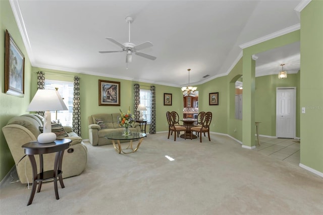 carpeted living room featuring ornamental molding and ceiling fan with notable chandelier