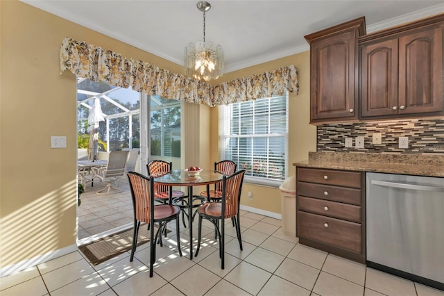 2831 Corinthia Cir, North Fort Myers, FL 33917 - dining room featuring crown molding, baseboards, a chandelier, and light tile patterned floors