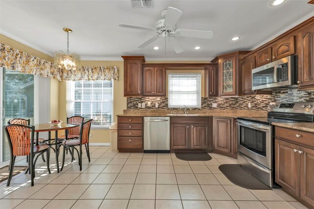 2831 Corinthia Cir, North Fort Myers, FL 33917 - kitchen featuring stainless steel appliances, ornamental molding, a sink, and tasteful backsplash