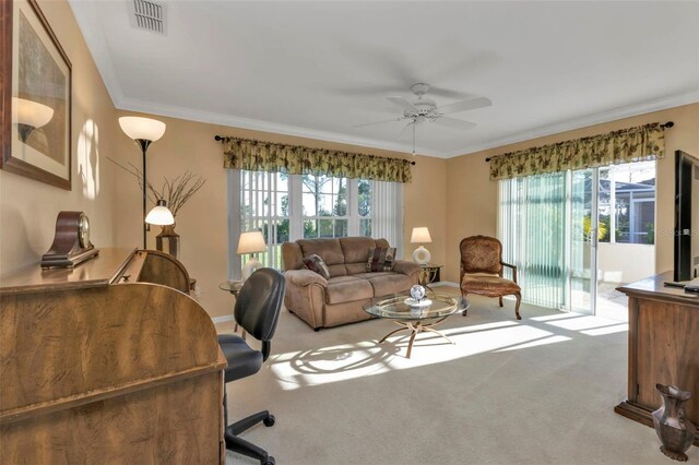 2831 Corinthia Cir, North Fort Myers, FL 33917 - carpeted living room featuring visible vents, a ceiling fan, crown molding, and a healthy amount of sunlight