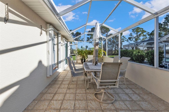 view of patio featuring a lanai