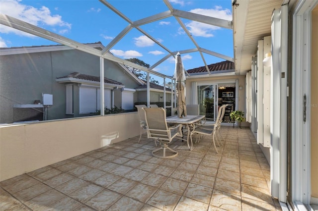 view of patio / terrace featuring a lanai