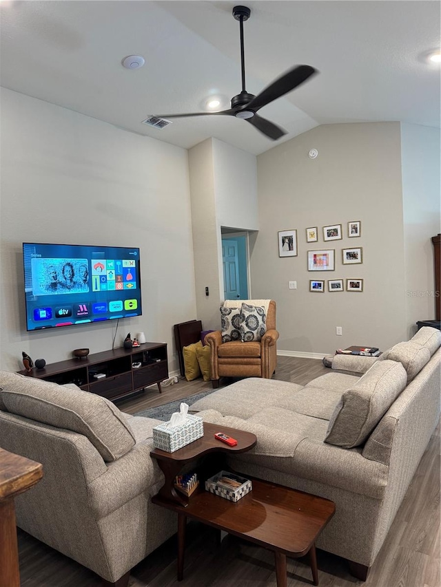 living room featuring ceiling fan, wood-type flooring, and lofted ceiling