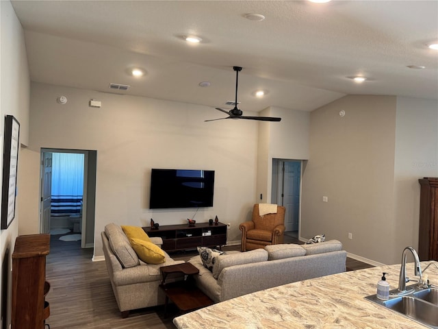 living room with dark hardwood / wood-style floors, ceiling fan, lofted ceiling, and sink