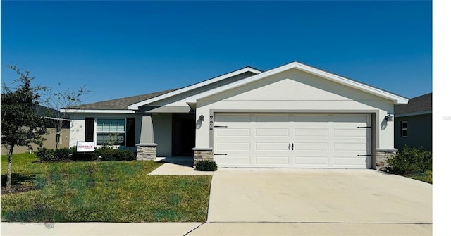 craftsman inspired home featuring a garage and a front yard