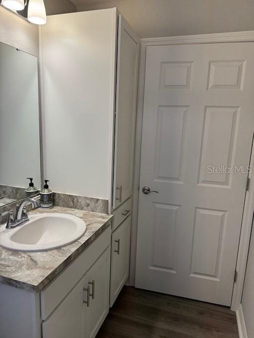 bathroom with vanity and hardwood / wood-style flooring